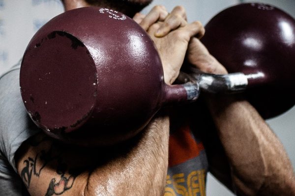 A man lifting kettlebells
